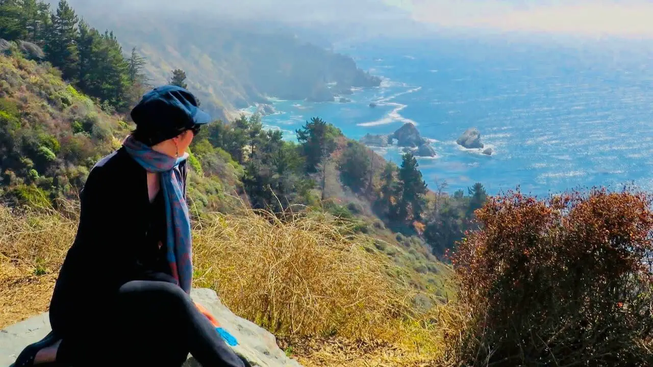 Girl looking towards pacific ocean at grimes overlook