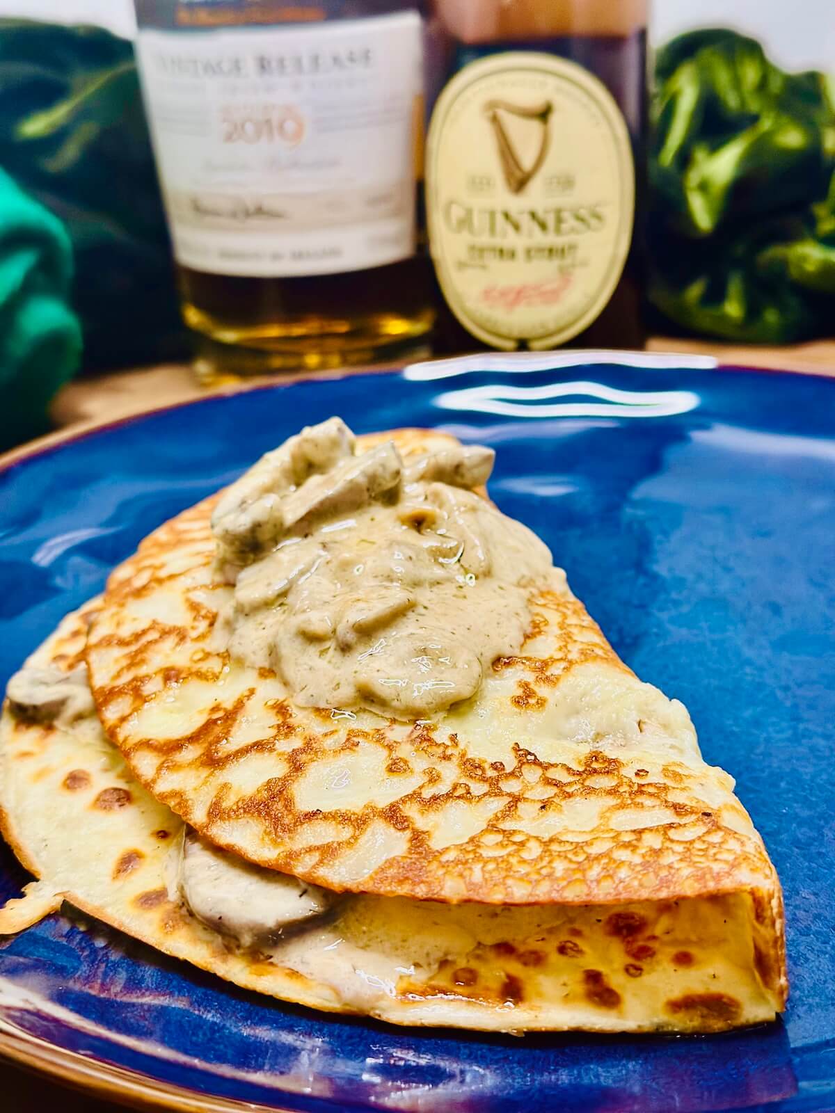 Boxty with mushroom sauce on blue plate